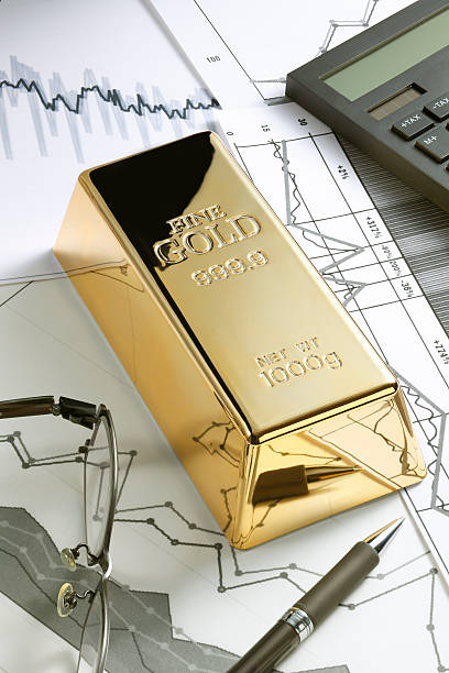Execution Traders gold ingot resting on a stock market graph representing investment or banking